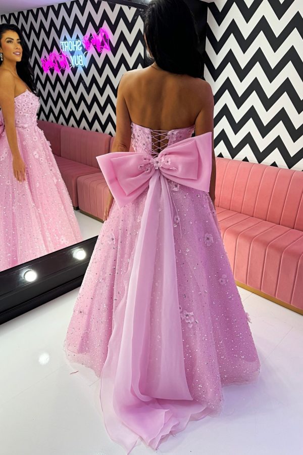 To the nines TNP248 full a-line ballgown, strapless dress with sparkle layer, beading, embellishments and 3D floral appliqués. Detachable bow on back, along with corset fastening