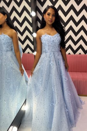 To the nines TNP248 full a-line ballgown, strapless dress with sparkle layer, beading, embellishments and 3D floral appliqués. Detachable bow on back, along with corset fastening