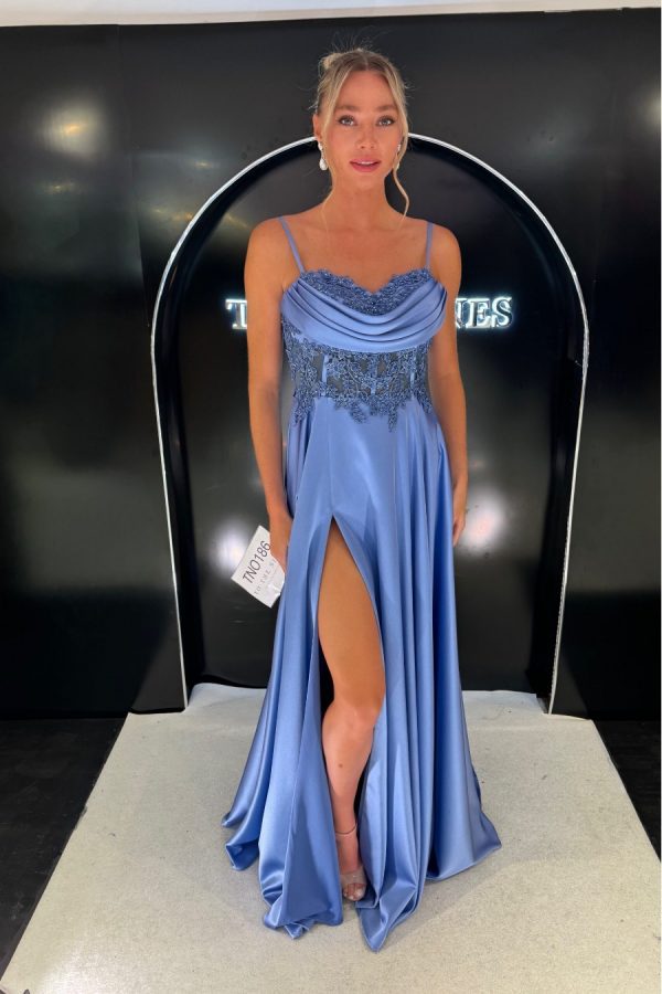 Soft satin baby a-line dress with leg split. Bodice section is finished with sparkle lace appliqués, cowl over the bust and corset back. This dress also has pockets!