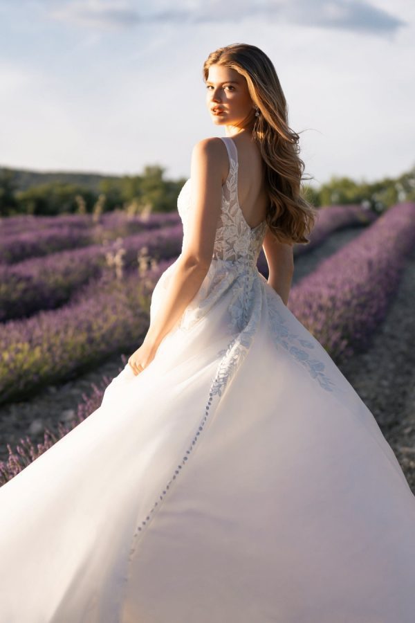 This A-line gown feautres a full sparkle tulle skirt topped with a sleeveless, sequined lace bodice.