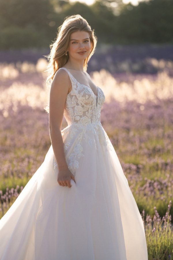 This A-line gown feautres a full sparkle tulle skirt topped with a sleeveless, sequined lace bodice.