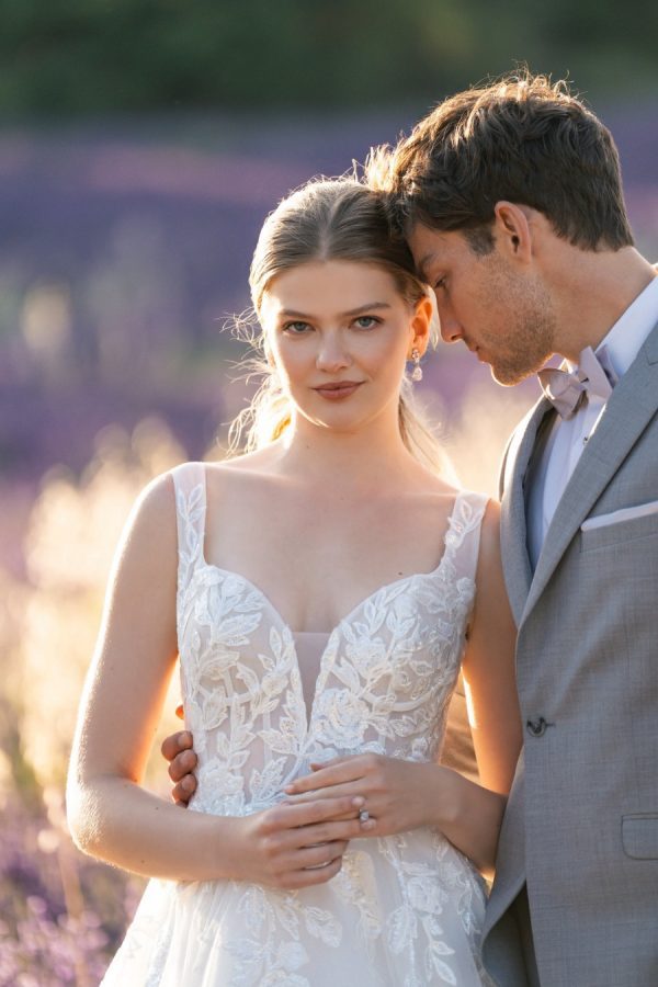 This A-line gown feautres a full sparkle tulle skirt topped with a sleeveless, sequined lace bodice.