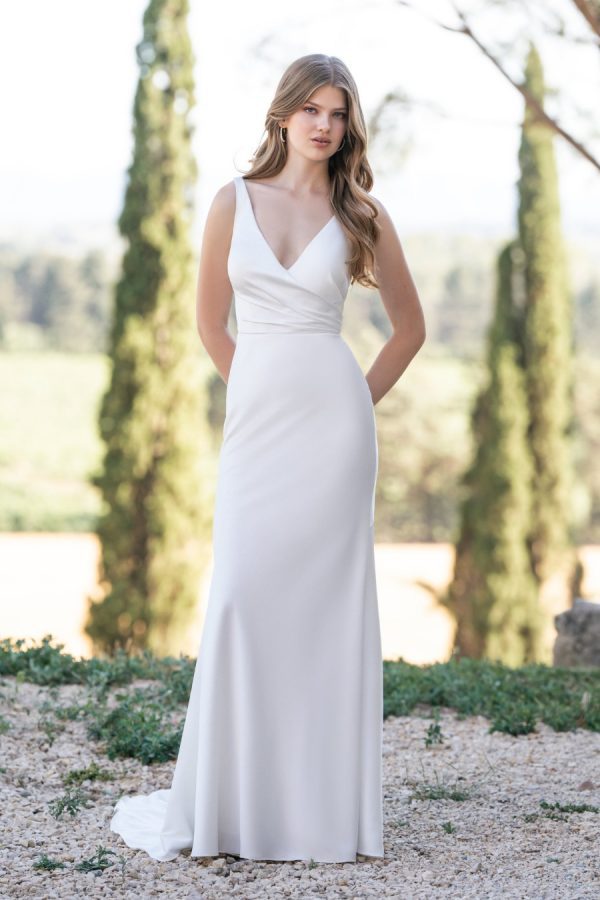 Graced with Chantilly lace accents and a tie back, this stretch satin sheath is both demure and lovely. Allure Romance - R3814