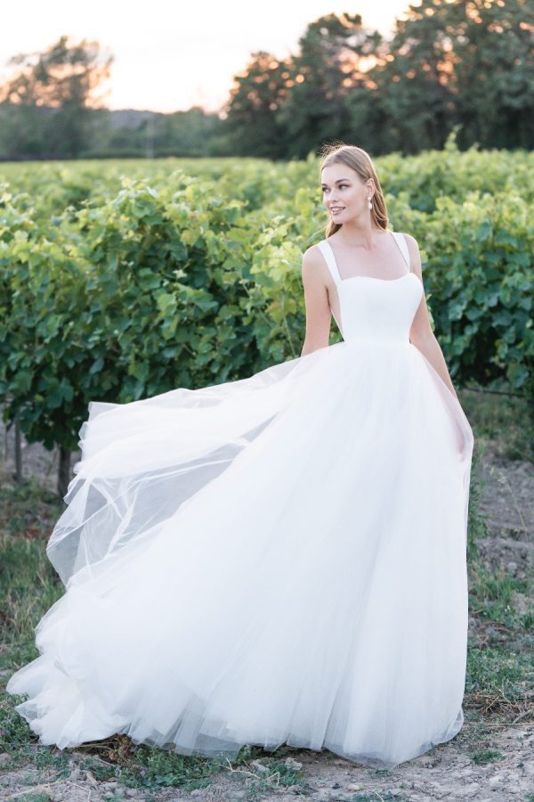 Contrasting textures in the form of Mikado and tulle are the perfect pairing in this sleeveless ballgown, finished with side panel cut outs and a tapered back. Allure Romance - R3807