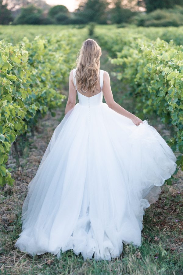 Contrasting textures in the form of Mikado and tulle are the perfect pairing in this sleeveless ballgown, finished with side panel cut outs and a tapered back. Allure Romance - R3807