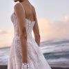 Opal by Milla Nova. A Romantic A-line wedding gown crafted from delicate lace with intricate floral detailing and sparkling all-over sequins. Featuring a boned drop-waist semi-sheer lace corset that flatters the figure, a heart-shaped neckline with subtle V-cut and detachable cups, embellished spaghetti straps, and a closed back with a zip closure. The maxi skirt, made from layers of lace with a nude underskirt, flows gracefully into a midi train, adding an ethereal finish. 
The gown can be elevated with an Opal fingerless gloves.