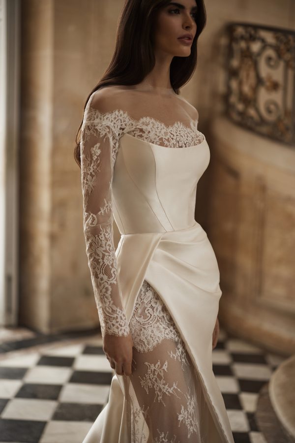 Aldrans by Milla Nova. Simplicity meets pure elegance, featuring a delicate Chantilly lace leg split, this gown is the perfect balance of timeless beauty and modern charm.