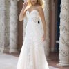 Evelyn by Allure Romance - Minimal in silhouette but rich in detail, this strapless sheath gown features a sweetheart neckline and a sheer bodice with exposed boning beneath sequin lace appliques. The soft tulle layers fall from a natural waistline into a clean, floor-length hem for an effortlessly refined finish.